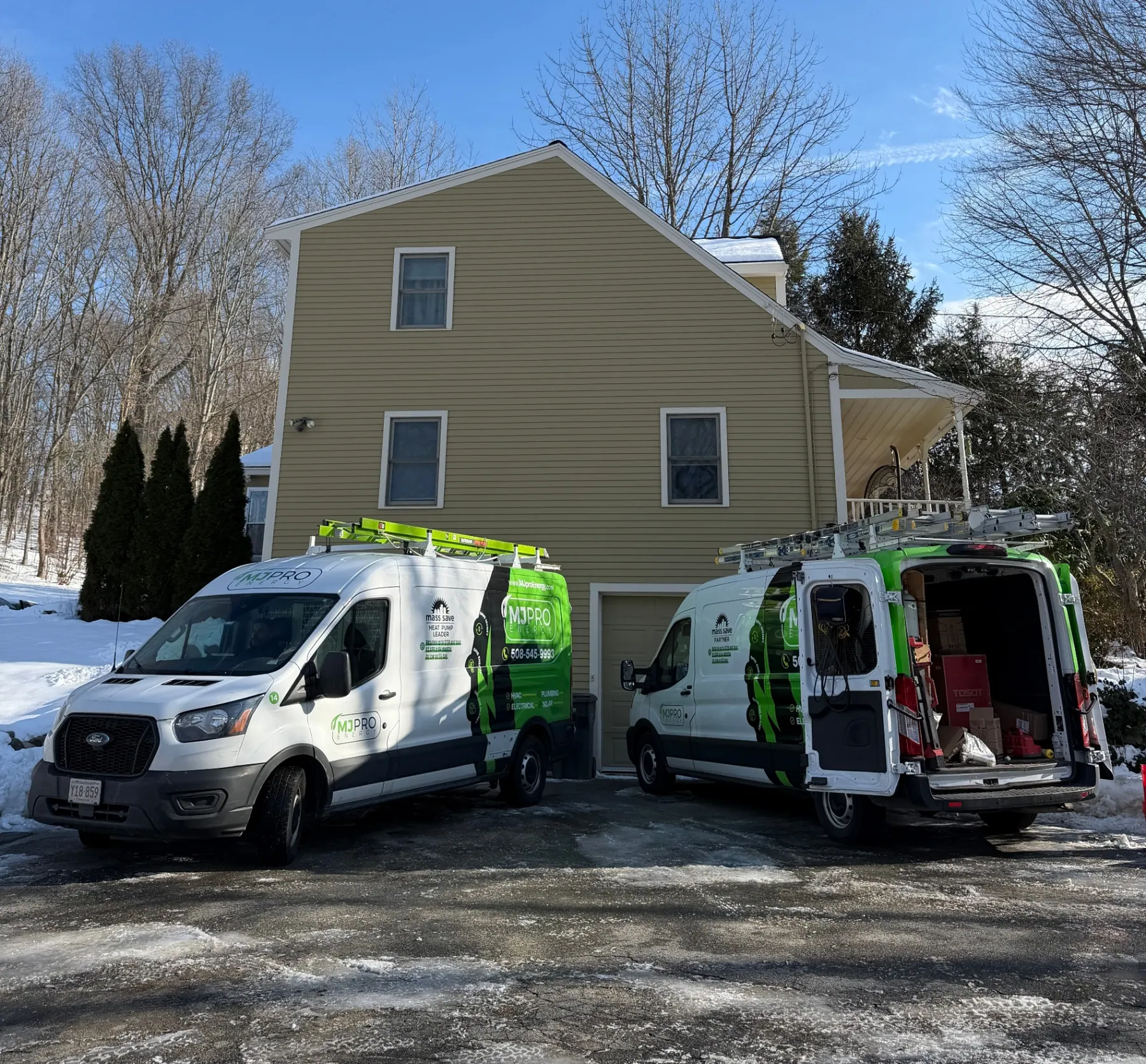 MJ Pro Energy service vans at a Greater Boston home