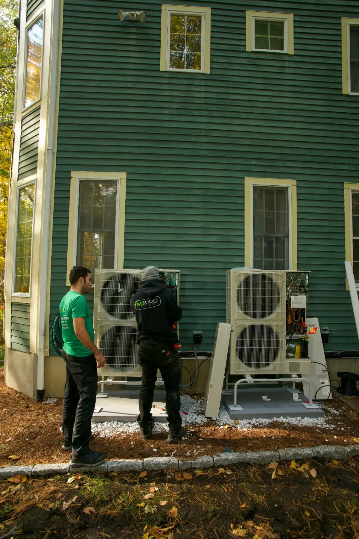 MJ Pro Energy technicians installing heat pumps at a Massachusetts home