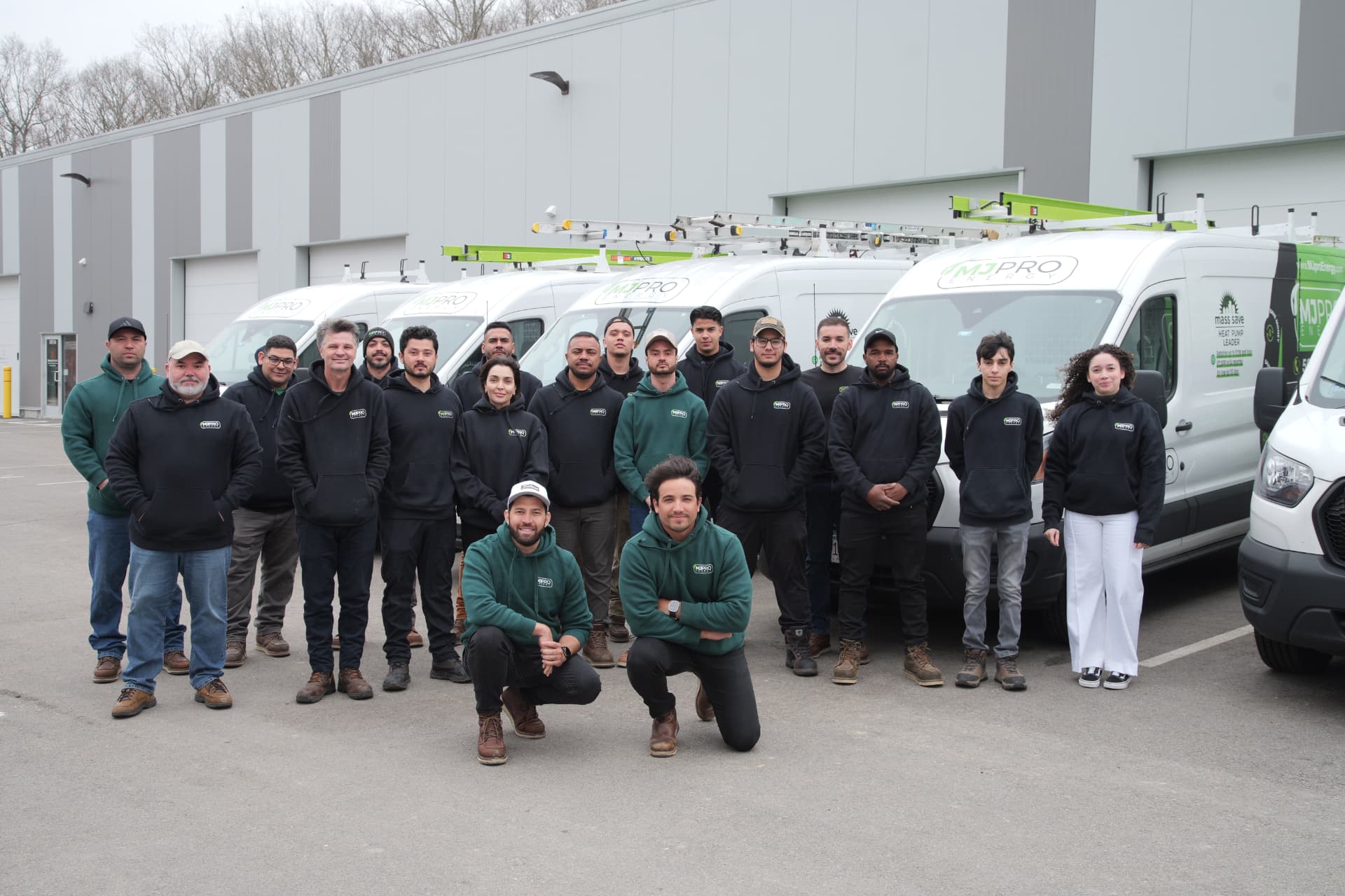 MJ Pro Energy team standing in front of their service vans